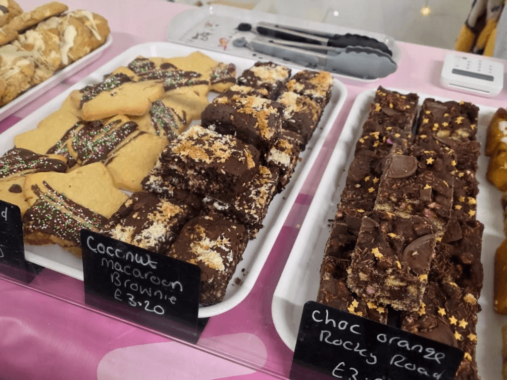 Selection of homemade cakes, brownies and sweet treats on display at a food stall during a makers market at Leigh Spinners Mill.