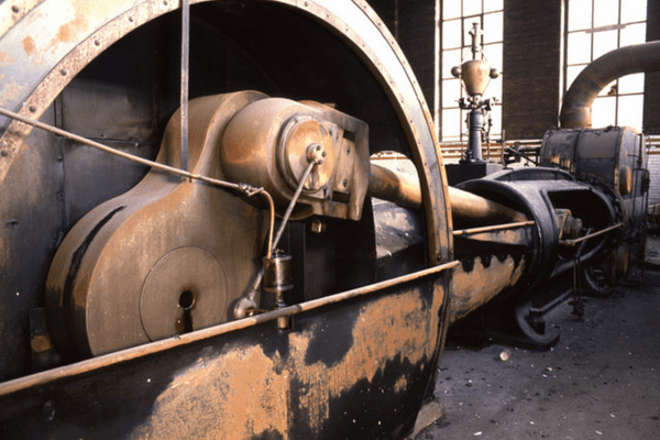 Mayor & Mayoress steam engine at Leigh Spinners Mill before restoration, showing the large flywheel and original industrial machinery within the engine house.