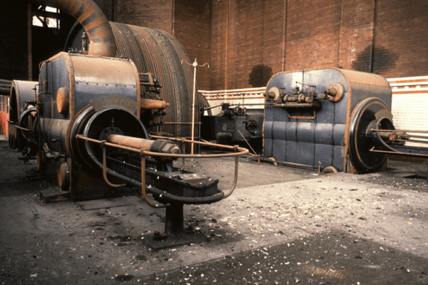 Mayor & Mayoress steam engine at Leigh Spinners Mill before restoration, showing the twin engine units, flywheel and machinery inside the original engine house.