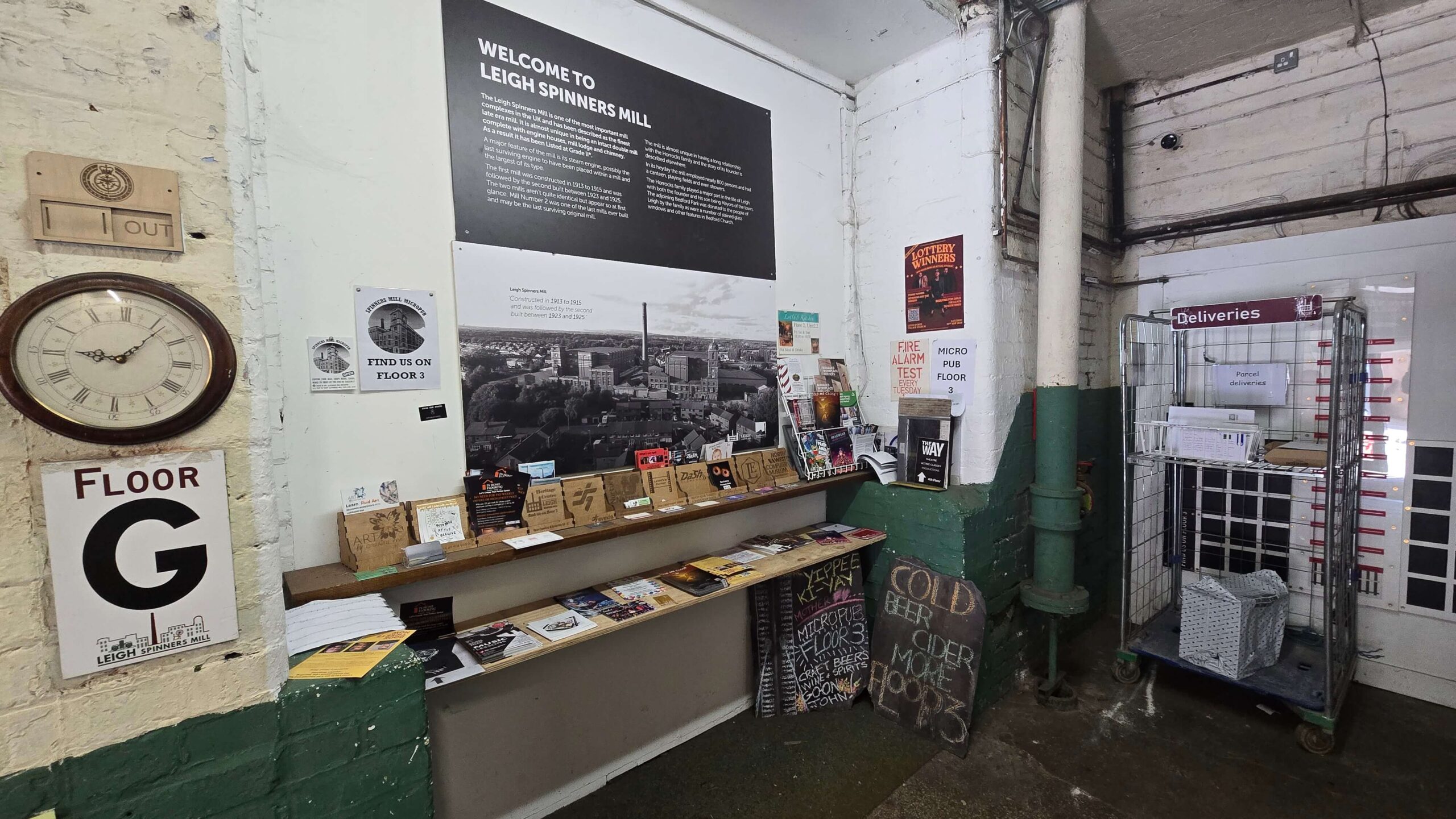 Information point inside Spinners Mill featuring building history, business leaflets, floor guides, and original industrial features.