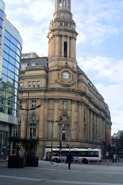 Exterior view of Manchester Royal Exchange, designed by Bradshaw Gass & Hope, showing the landmark clock tower, classical columns and historic city centre architecture