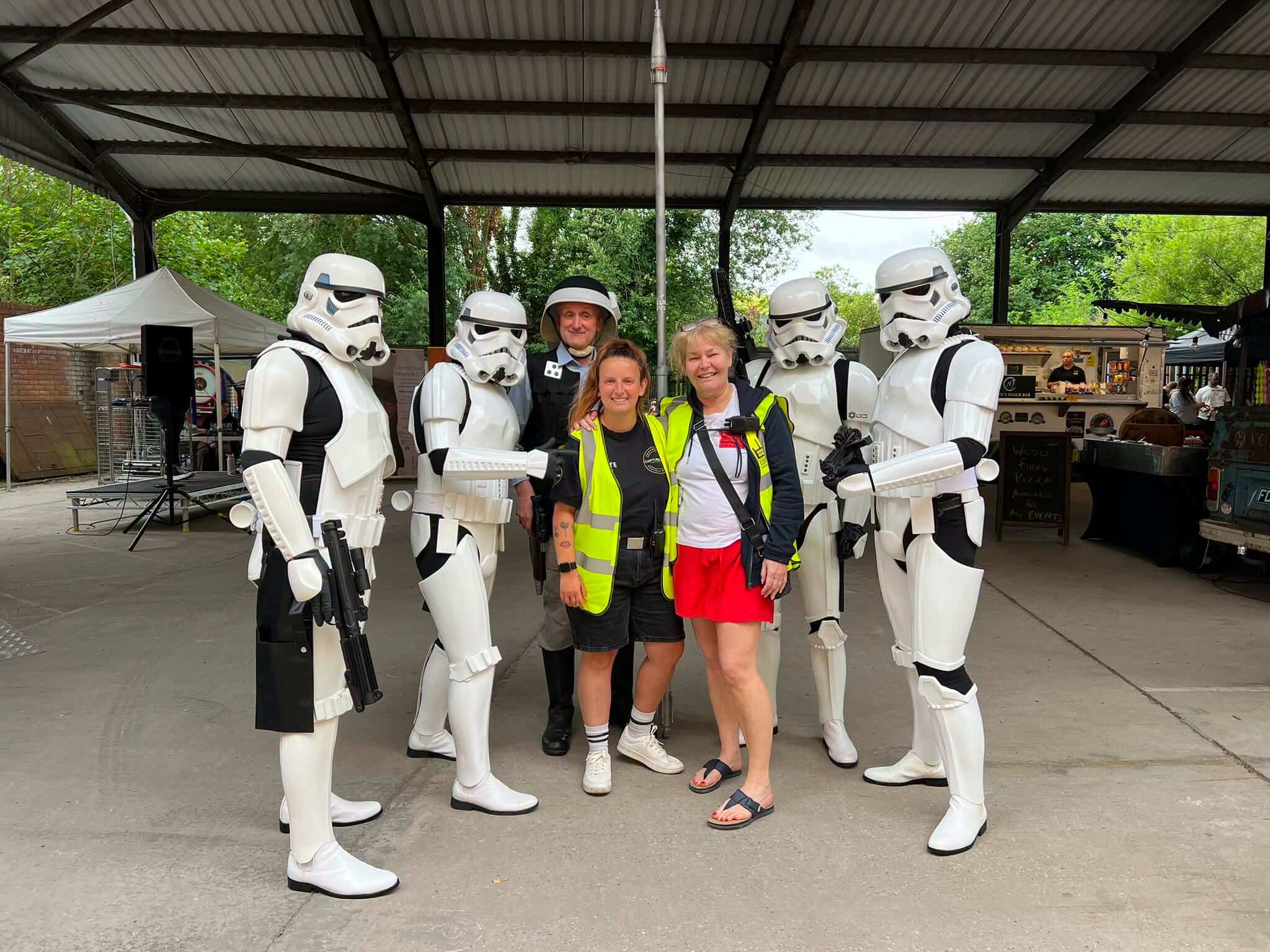 Market organisers posing with Stormtroopers and Star Wars characters during a themed event at Leigh Spinners Mill Makers Market.